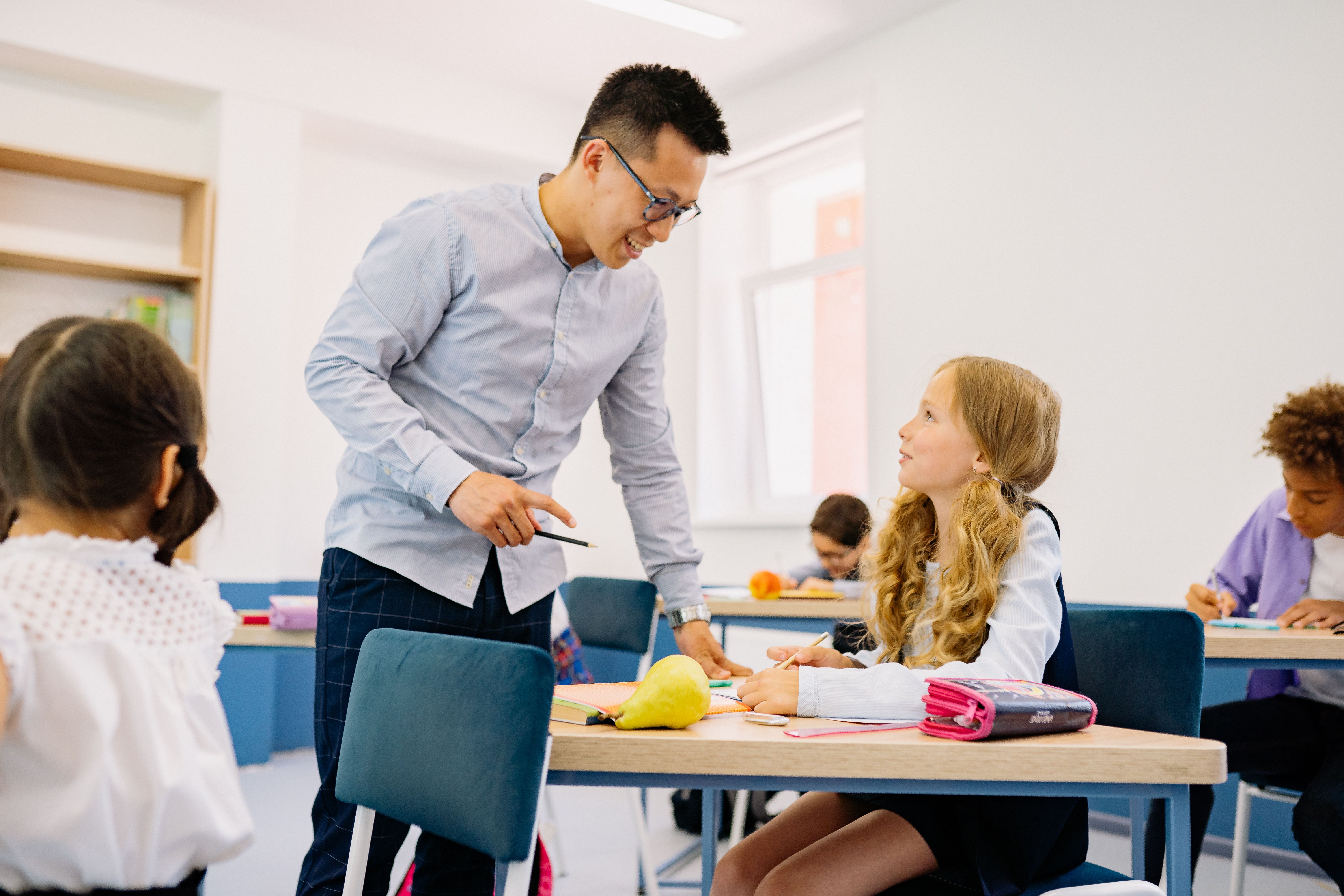 Teacher talking to pupil, school safeguarding changes 2026